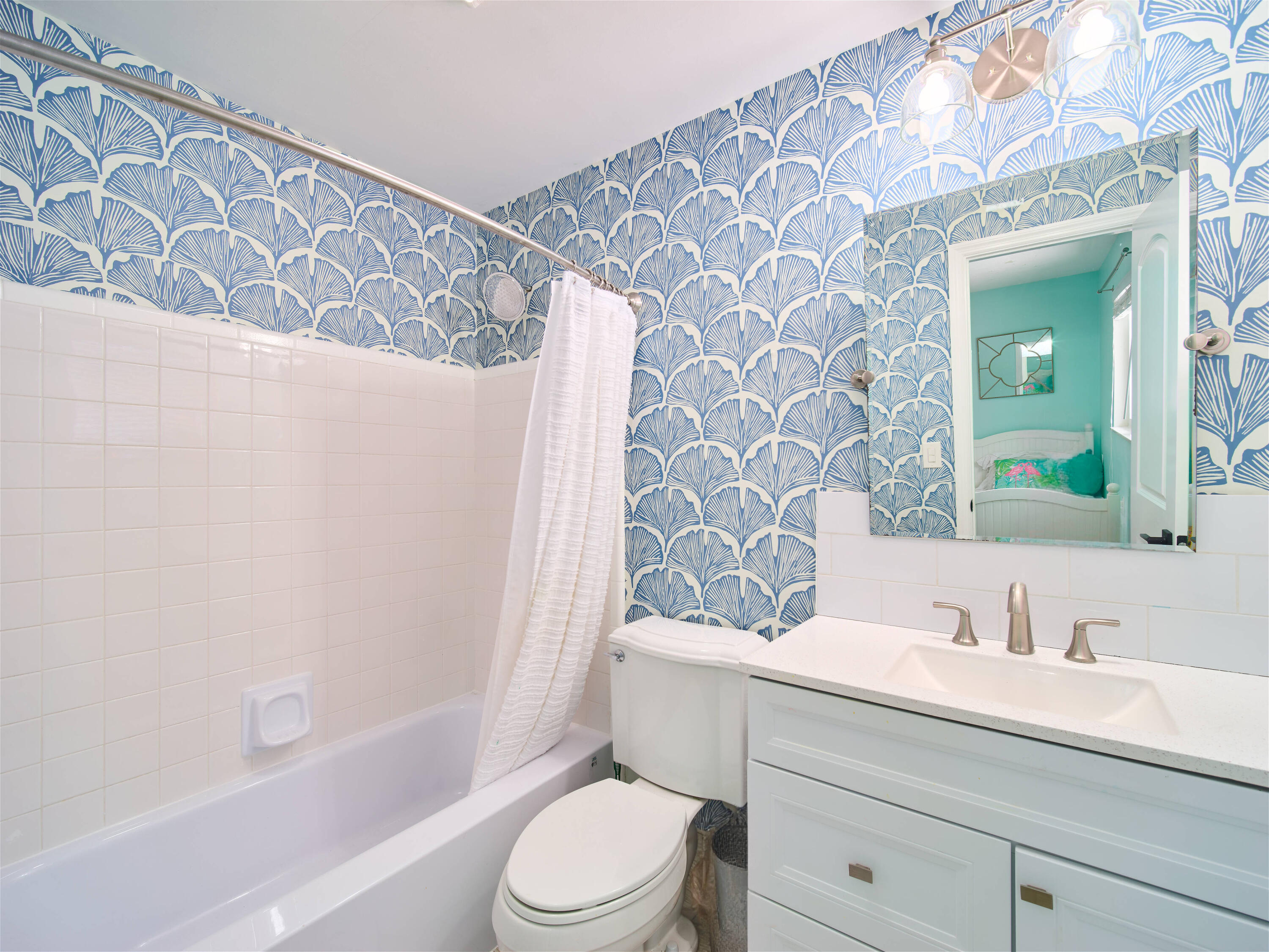 359 Church Road Tequesta, FL 33469 - Photo 20 of 30 a bathroom with a granite countertop bathtub sink vanity mirror and toilet