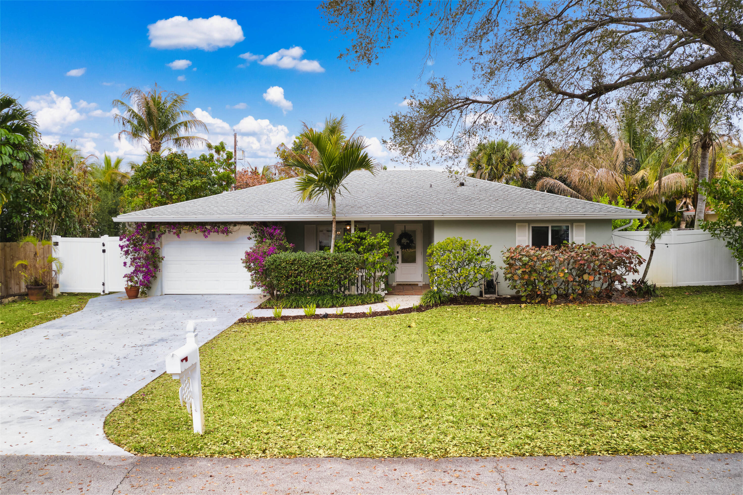 359 Church Road Tequesta, FL 33469 - Photo 2 of 30 a front view of a house with garden