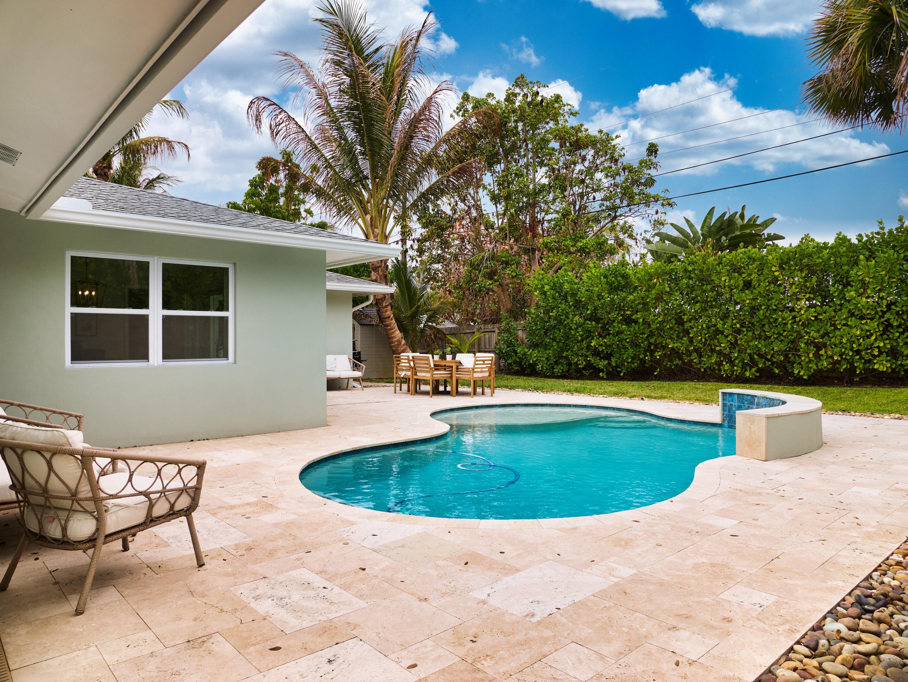 359 Church Road Tequesta, FL 33469 - Photo 22 of 30 a view of a swimming pool with a patio