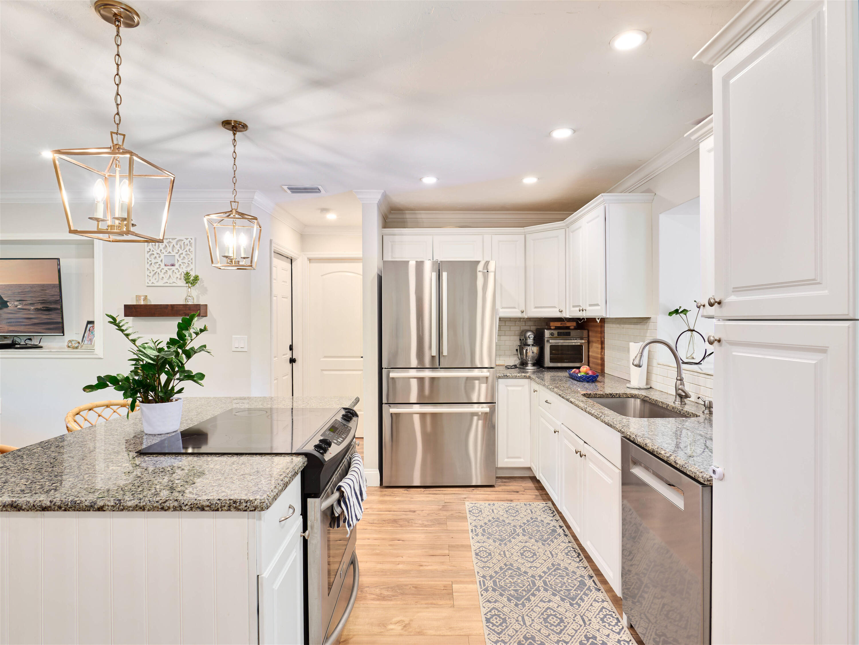 359 Church Road Tequesta, FL 33469 - Photo 8 of 30 a kitchen with stainless steel appliances granite countertop a sink a stove and a refrigerator