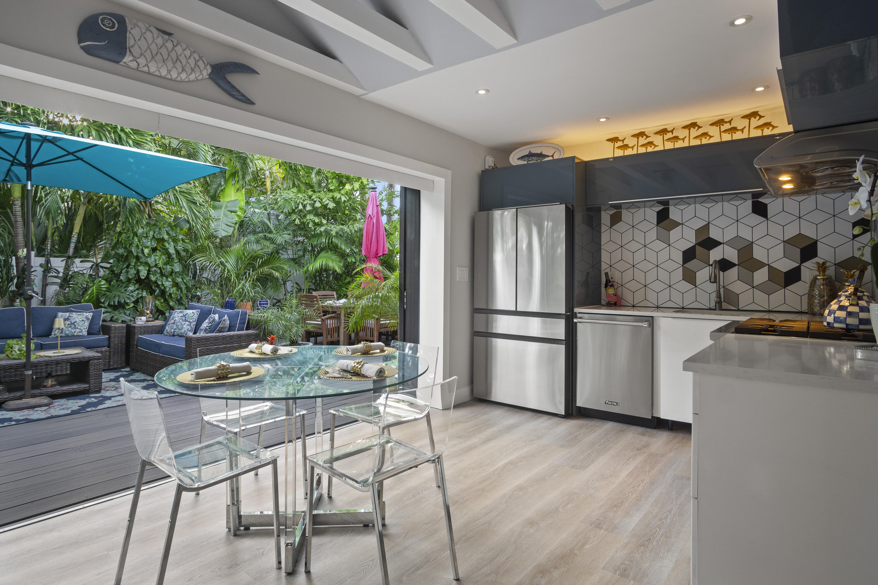 1616 Bertha Street, Unit 2 Key West, FL 33040 - Photo 19 of 45 a kitchen with stainless steel appliances wooden floor and a refrigerator