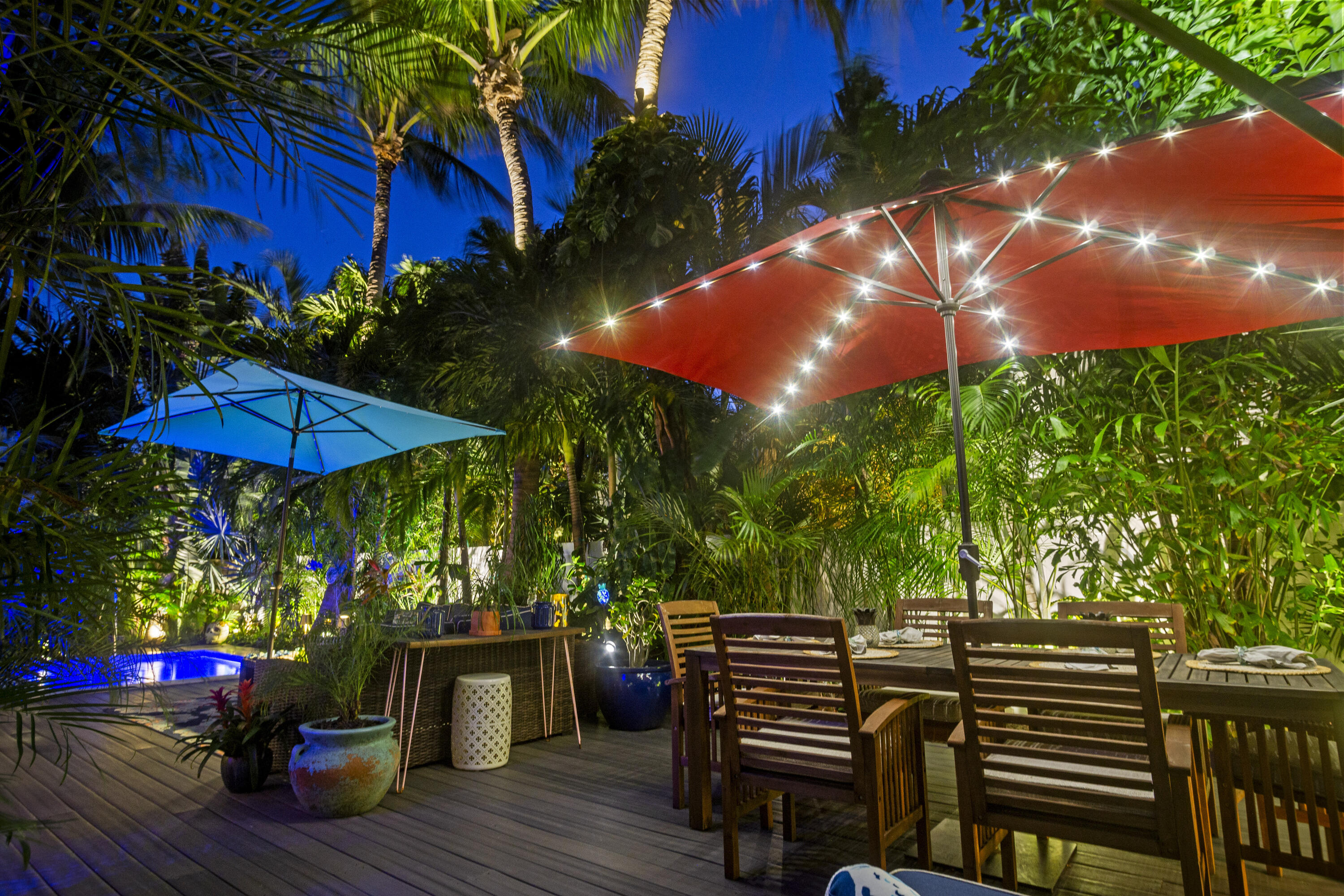 1616 Bertha Street, Unit 2 Key West, FL 33040 - Photo 4 of 45 a view of a chairs and table under an umbrella in patio of a house