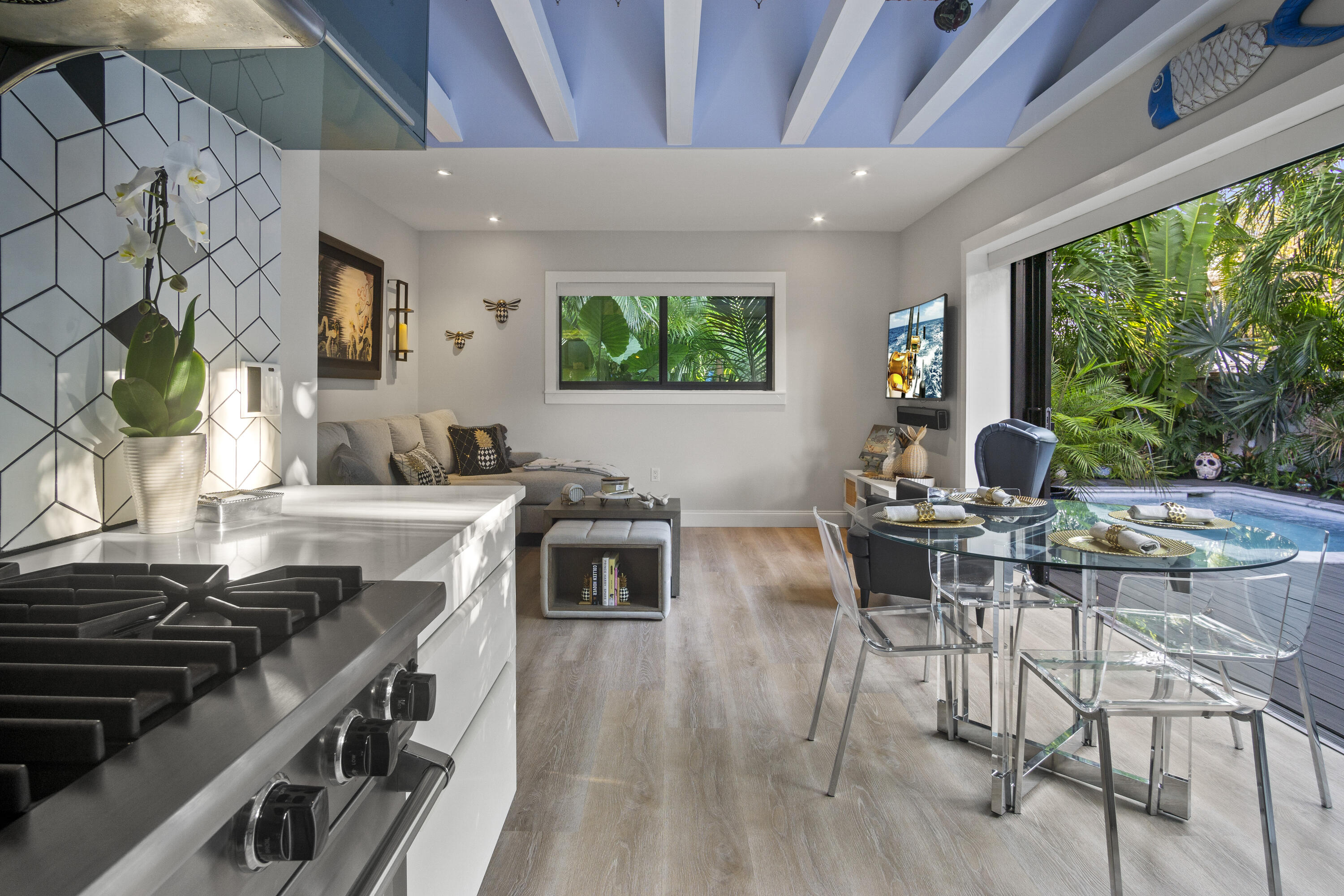 1616 Bertha Street, Unit 2 Key West, FL 33040 - Photo 10 of 45 a kitchen with a stove a sink a counter top space and living room area