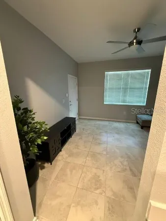 a bed room with furniture and a potted plant