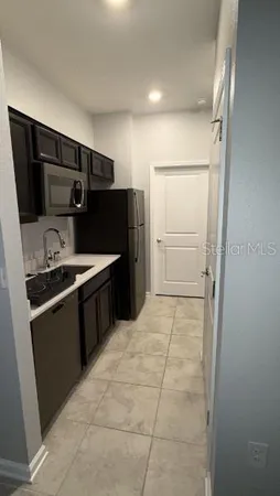 a utility room with cabinets washer and dryer