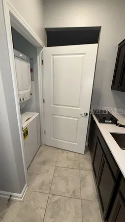 a bed sitting in a spacious bedroom next to a window