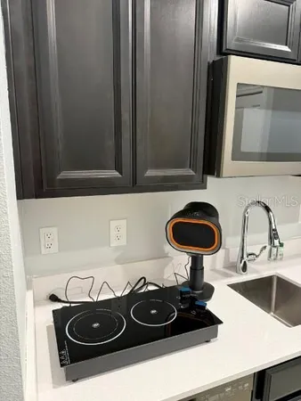 a kitchen with stainless steel appliances a sink a stove and microwave
