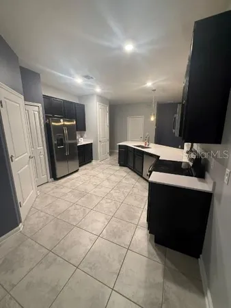 a kitchen with stainless steel appliances a refrigerator and a stove top oven