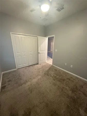 an empty room with a empty space and windows