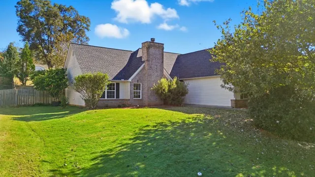 a front view of house with yard and green space