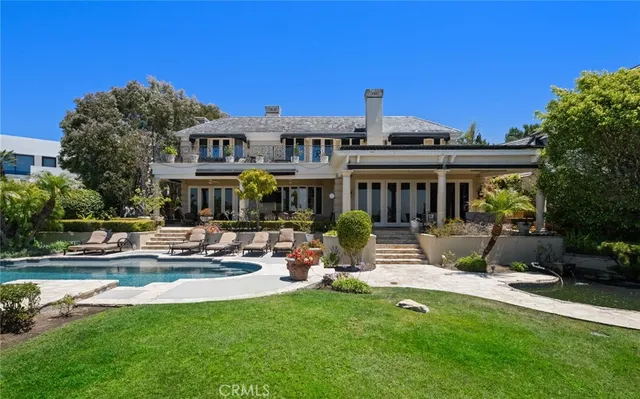 a view of a house with a yard patio and fire pit