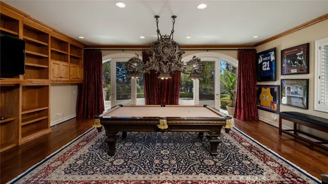 a room with musical instrument pool table and windows