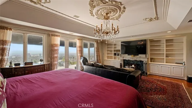 a bedroom with a bed and a flat tv screen on dresser