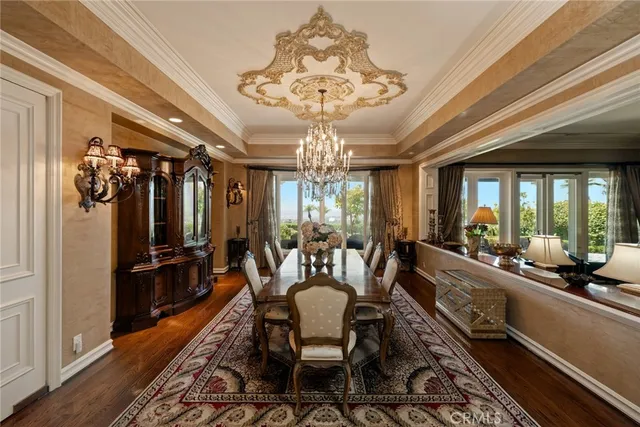 a view of a dining room with furniture a chandelier and chandelier