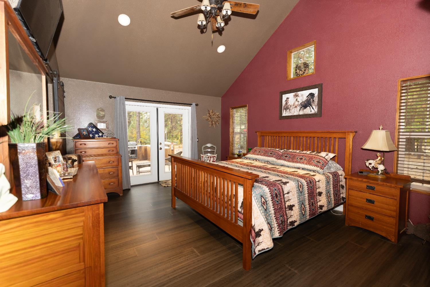 10070 Swiss Ranch Road Mountain Ranch, CA 95246 - Photo 15 of 64 a spacious bedroom with a bed and a chandelier