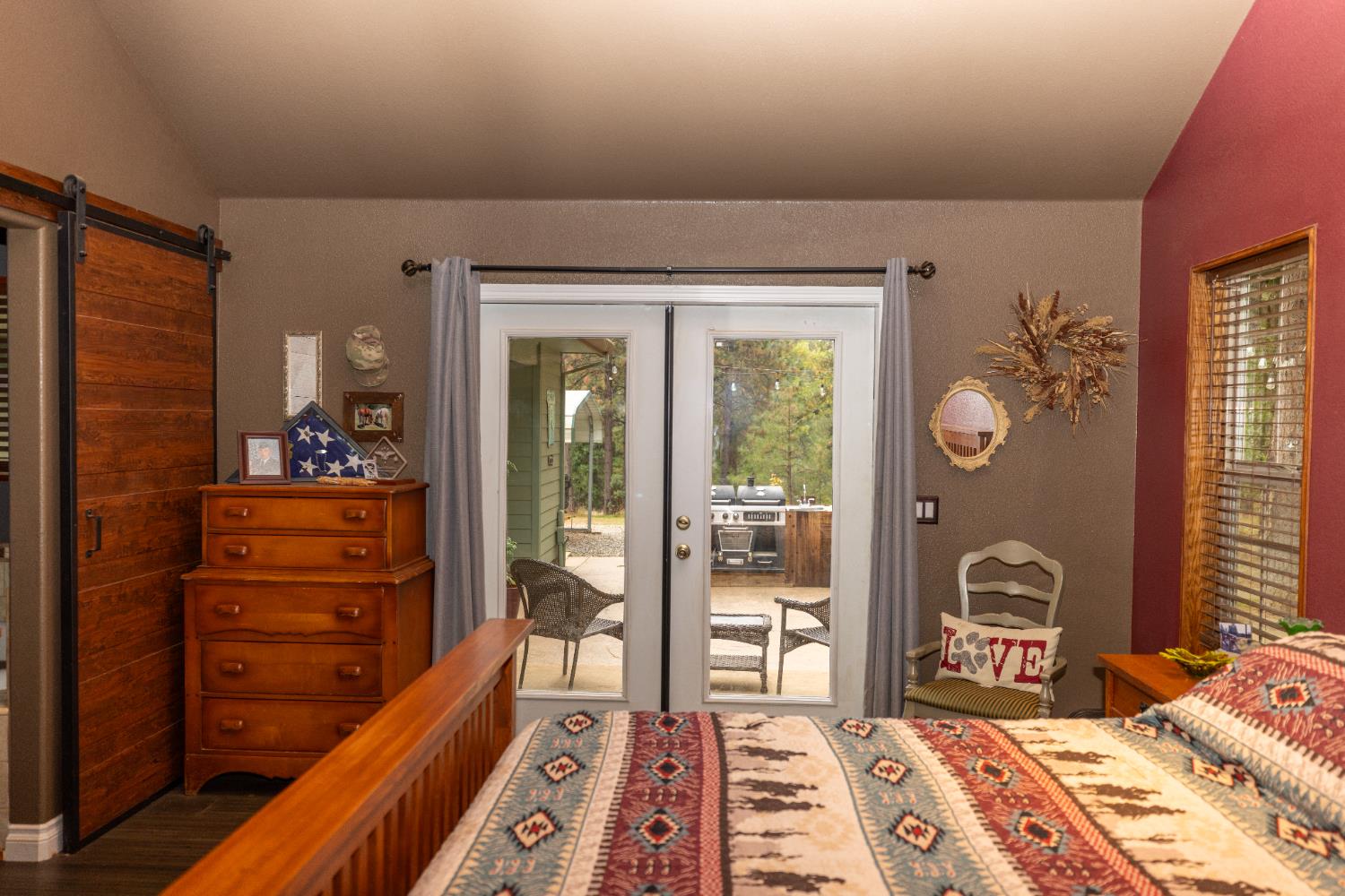 10070 Swiss Ranch Road Mountain Ranch, CA 95246 - Photo 16 of 64 a bedroom with a bed and wooden floor