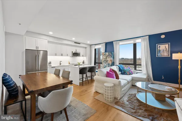 a living room with furniture wooden floor and a flat screen tv
