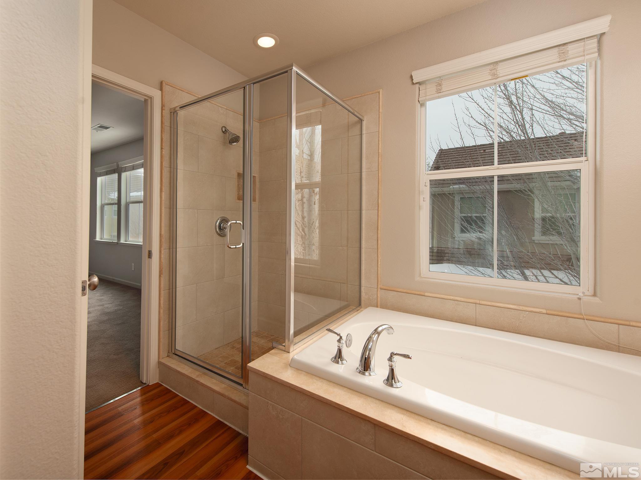 1609 Clover Hill Trail Reno, NV 89523 - Photo 22 of 36 a bathroom with a tub shower and window