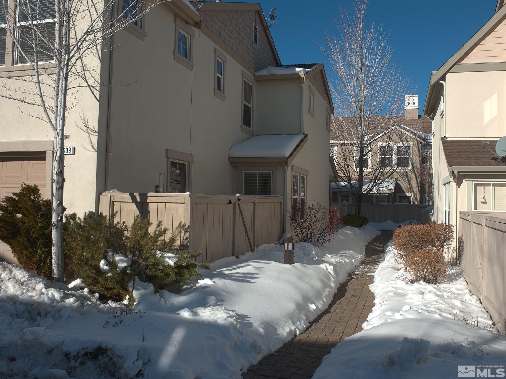 1609 Clover Hill Trail Reno, NV 89523 - Photo 4 of 36 a view of a house with a yard covered in snow
