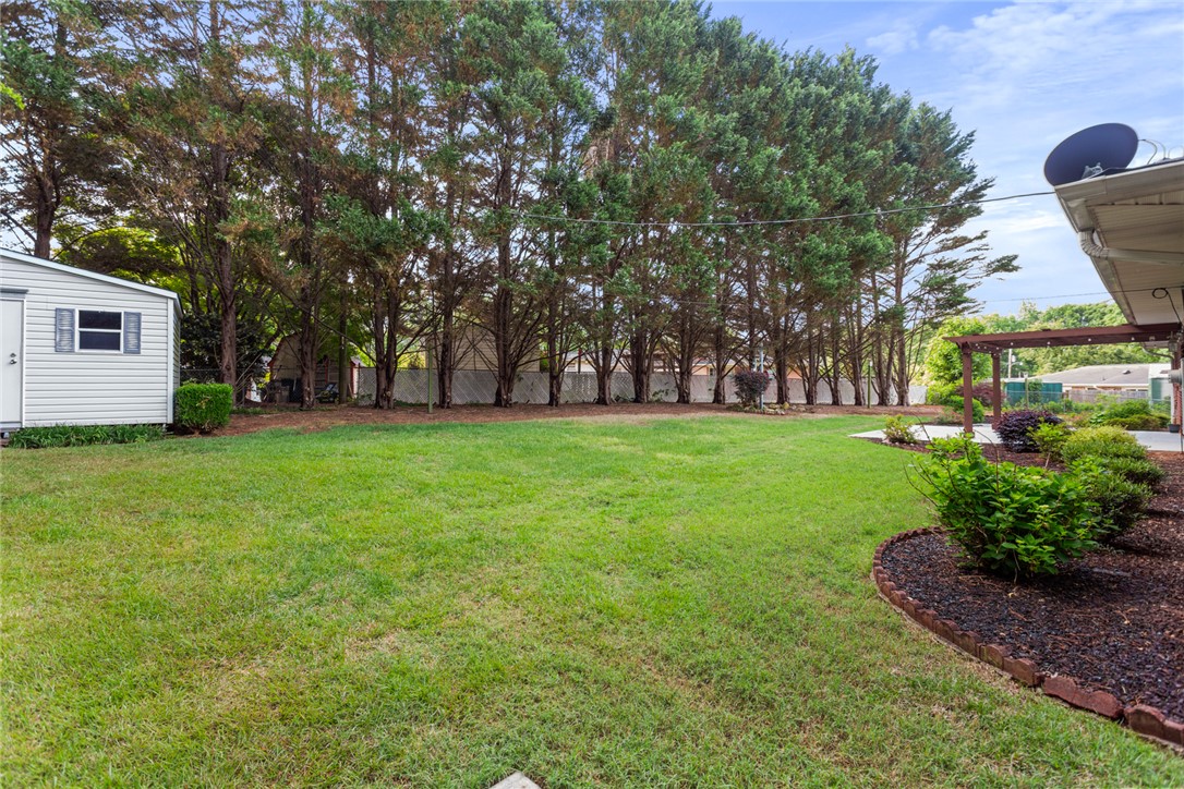 202 Keowee Trail Seneca, SC 29672 - Photo 27 of 35 This spacious yard offers a serene retreat with ample green space and a convenient shed.
