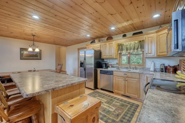 a bed sitting in a spacious bedroom next to a window