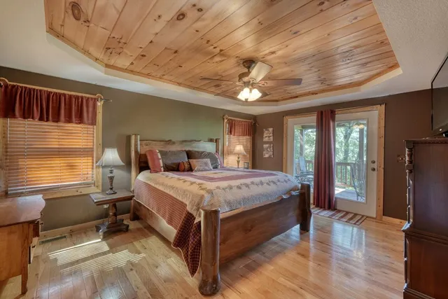 a bedroom with a large bed and a chandelier
