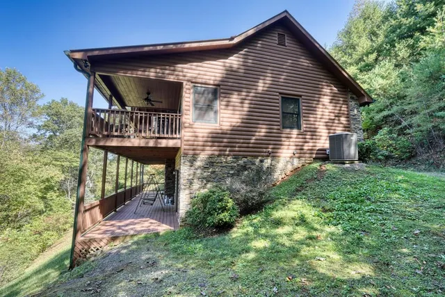 a bedroom with a bed dresser and a large window