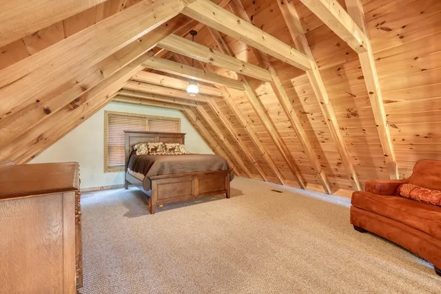 a bed sitting in a bedroom next to a window