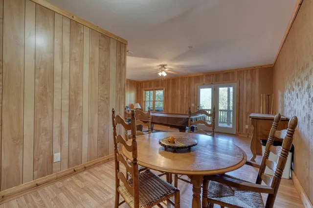 a living room with furniture a table and wooden floor