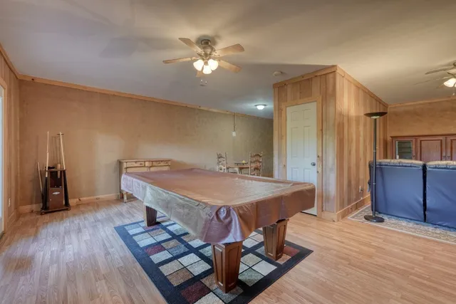 a living room with furniture a window and a flat screen tv