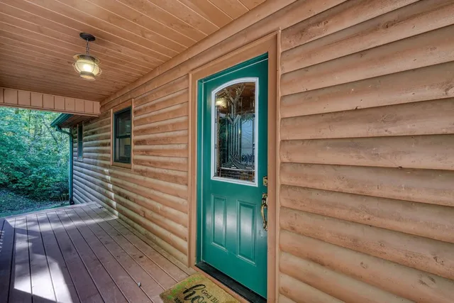 a view of a patio with table and chairs and wooden floor