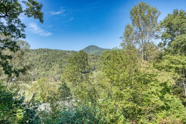 a kitchen with a dining table chairs and refrigerator