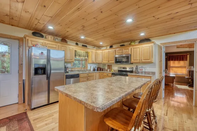 a kitchen with stainless steel appliances granite countertop a sink and cabinets