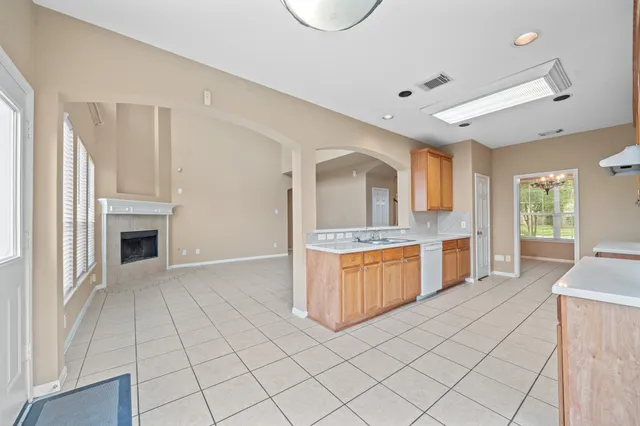 a large white kitchen with a sink and cabinets