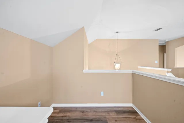 a view of a room with window and wooden floor