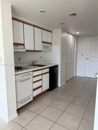 a kitchen with a cabinets and appliances