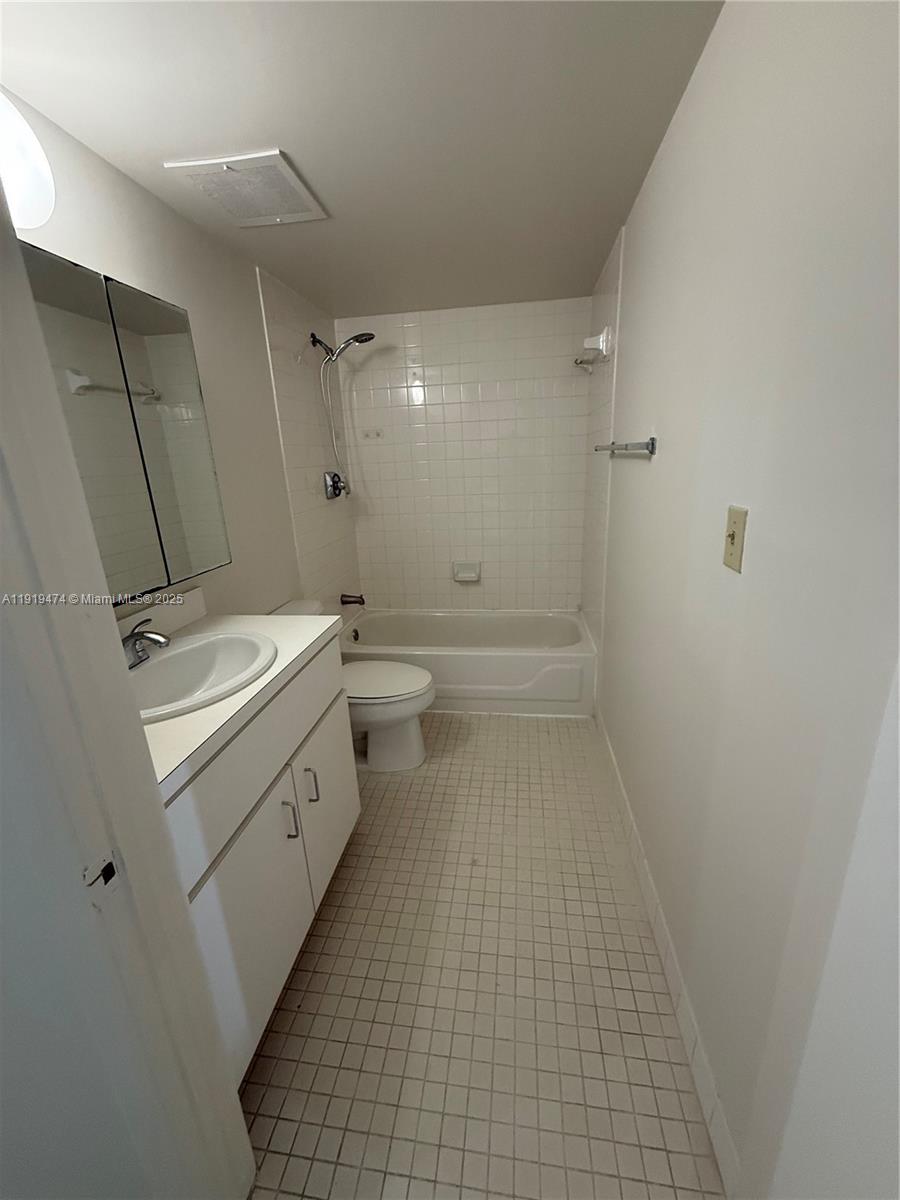 5717 Southwest 72nd Street, Unit 5717 South Miami, FL 33143 - Photo 4 of 6 a bathroom with a sink a toilet and shower