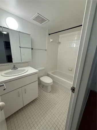 a bathroom with a sink a toilet a mirror and shower