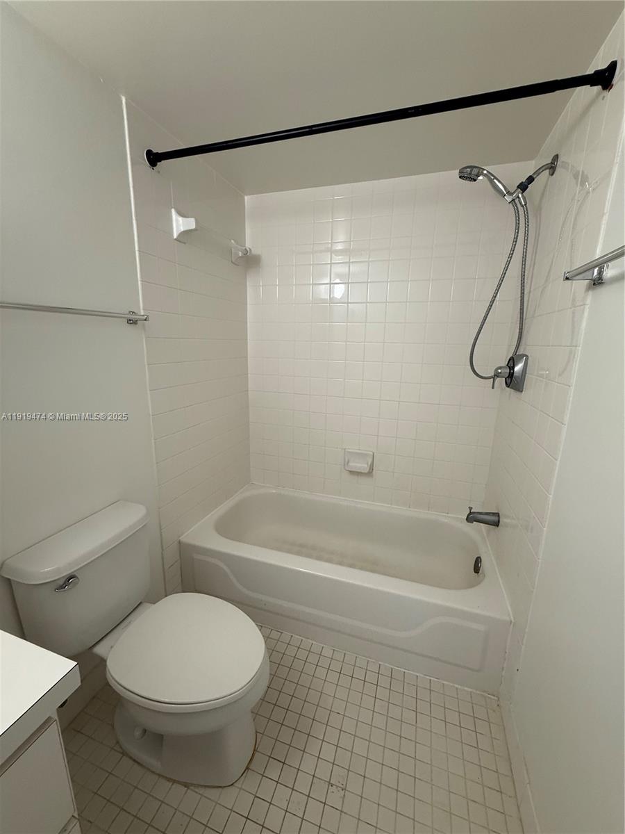 5717 Southwest 72nd Street, Unit 5717 South Miami, FL 33143 - Photo 6 of 6 a bathroom with a toilet and a shower