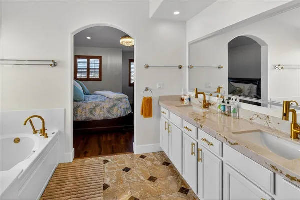 a white toilet sitting next to a bath tub