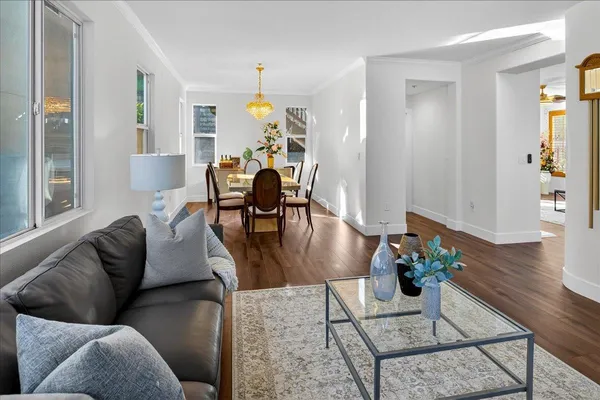 a dining room with furniture and wooden floor