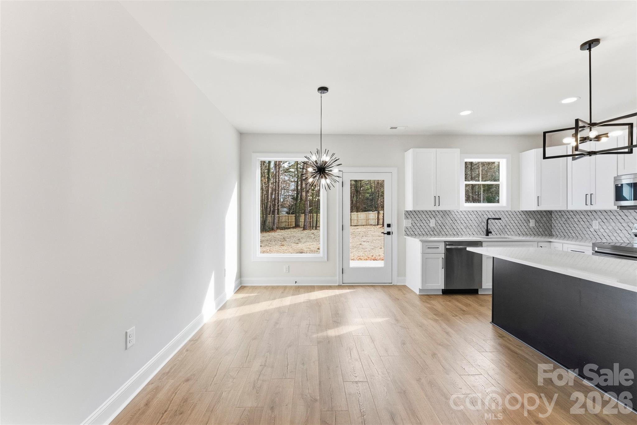 1724 Barnhardt Road China Grove, NC 28023 - Photo 12 of 46 a large kitchen with granite countertop a stove a sink dishwasher and a refrigerator with wooden floor