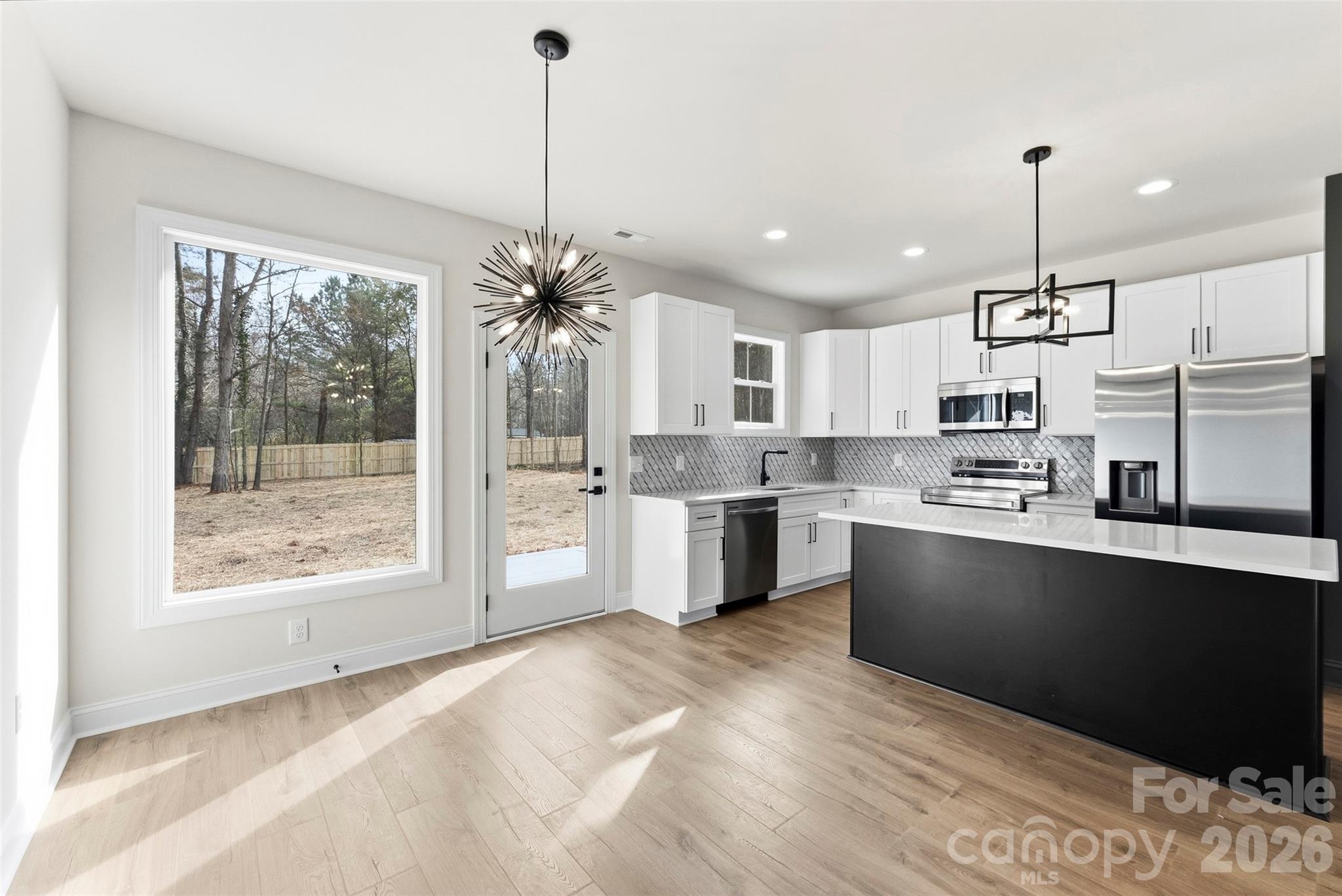 1724 Barnhardt Road China Grove, NC 28023 - Photo 13 of 46 a kitchen with stainless steel appliances granite countertop a sink a stove a refrigerator and cabinets