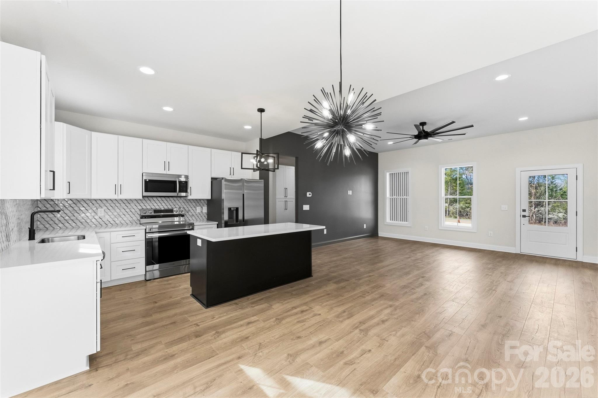 1724 Barnhardt Road China Grove, NC 28023 - Photo 14 of 46 a large kitchen with kitchen island a sink stainless steel appliances and cabinets