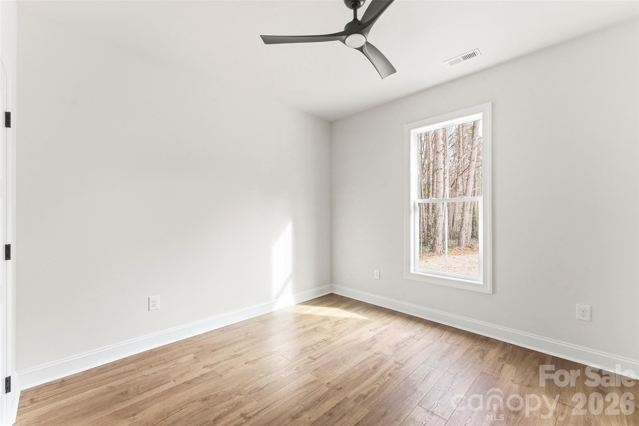 1724 Barnhardt Road China Grove, NC 28023 - Photo 31 of 46 an empty room with wooden floor fan and windows