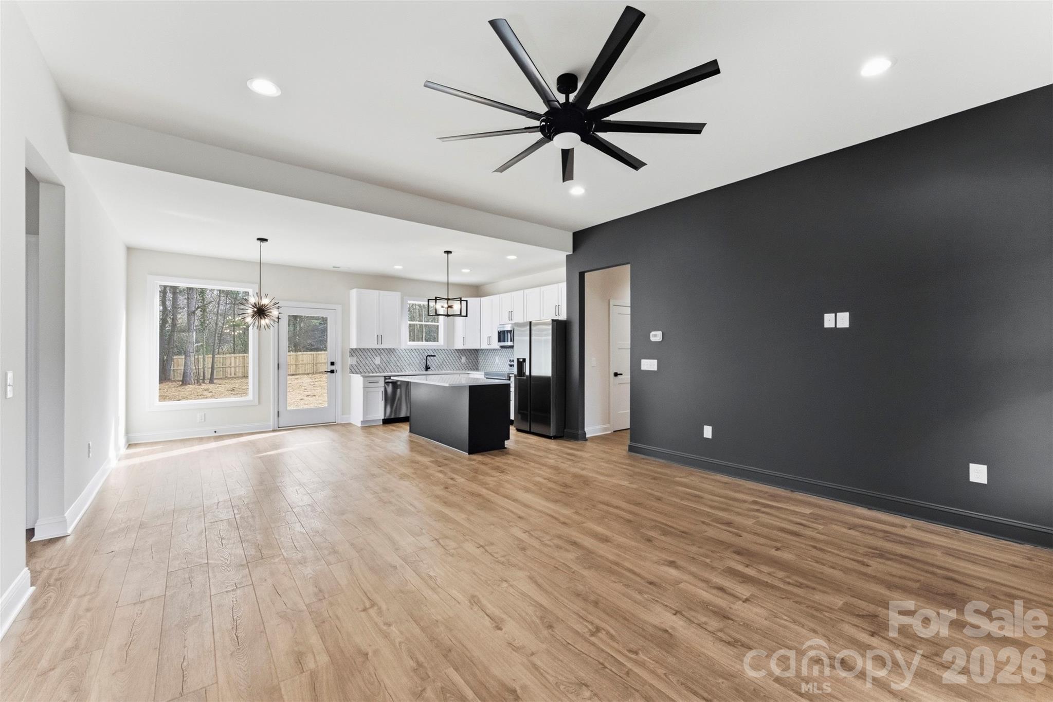 1724 Barnhardt Road China Grove, NC 28023 - Photo 5 of 46 a view of a livingroom with a kitchen counter top space cabinets and a ceiling fan