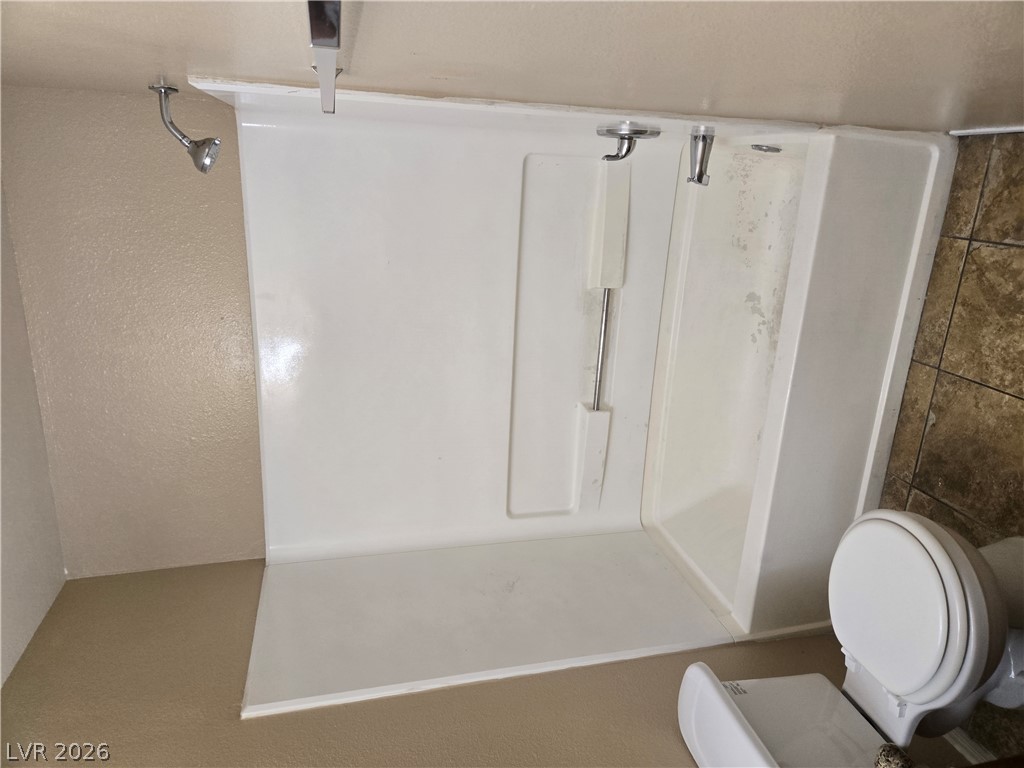 7200 West Pirates Cove Road, Unit 2047 Las Vegas, NV 89145 - Photo 14 of 17 A classic bathtub with an integrated shower offers a practical bathing solution.