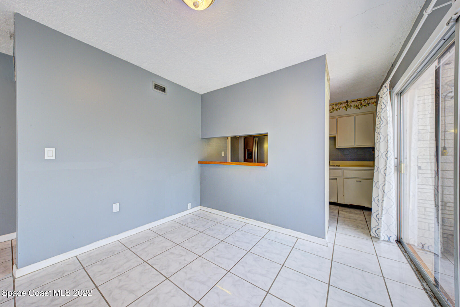 620 Java Road Cocoa Beach, FL 32931 - Photo 16 of 39 a view of an empty room with a kitchen