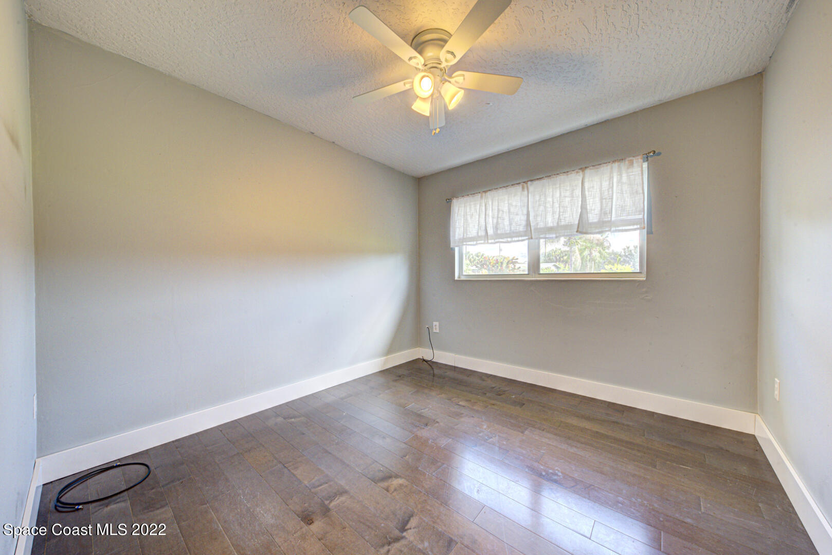 620 Java Road Cocoa Beach, FL 32931 - Photo 21 of 39 an empty room with windows and fan