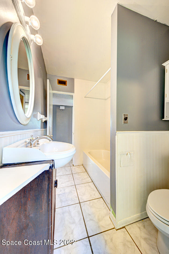 620 Java Road Cocoa Beach, FL 32931 - Photo 28 of 39 a bathroom with a sink a toilet and a mirror
